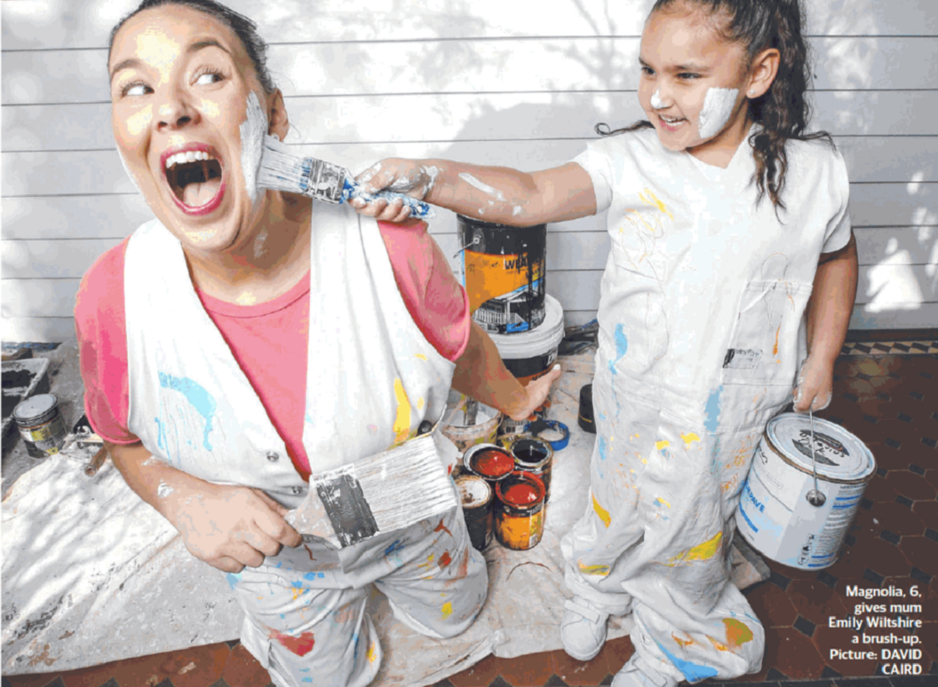 Mum and kid play fighting with paint