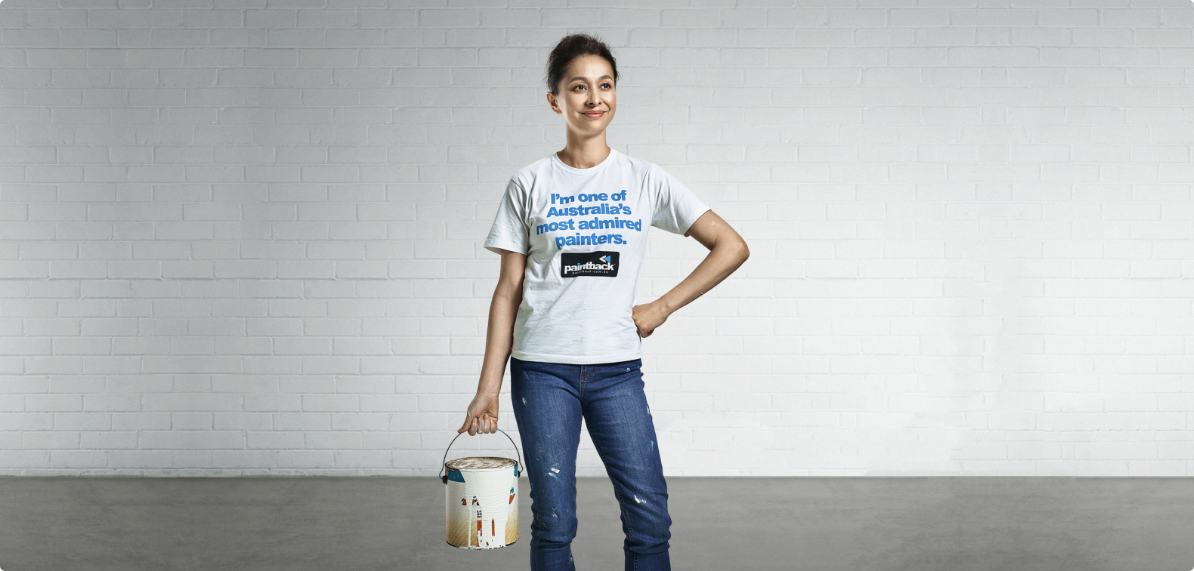 Women holden a paintbucket against white background