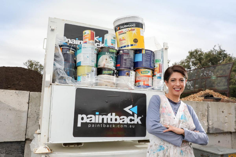 CEO paintback in front of paint buckets