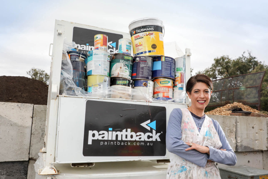 Paintback ceo in front of box of paint cans